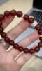 Holding 10mm Garnet Bracelet, Silver Details’ Metal Accent