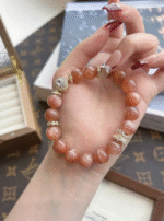 Holding 10mm Orange Moonstone Bracelet, Silver-Gold Accents Ignite Energy Field
