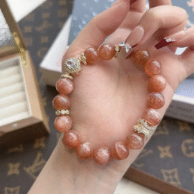 Holding 10mm Orange Moonstone Bracelet, Silver-Gold Accents Ignite Energy Field