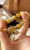 Holding 10mm Gold Tiger Eye & Citrine Bracelet, Metal Anchoring Details Of Silver-Gold Plated