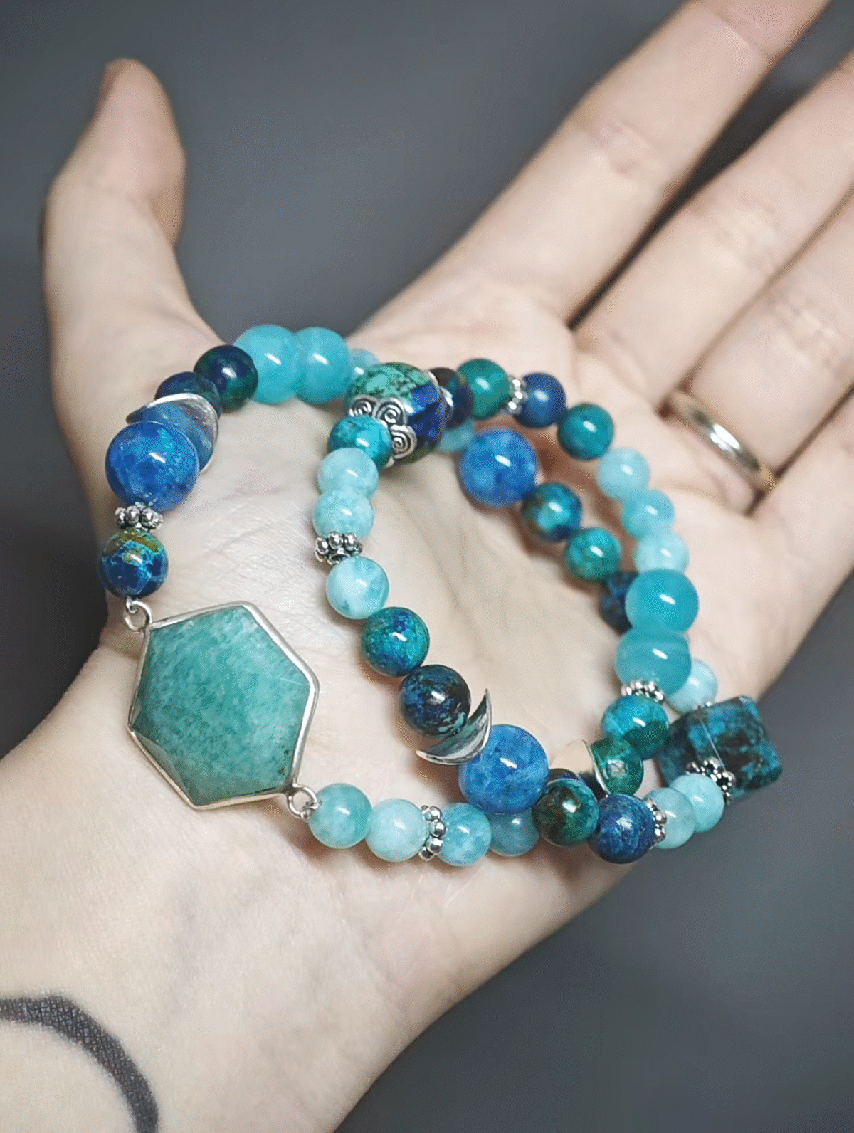 A double-strand bracelet with 8mm/6mm Amazonite and 7mm/10mm/13mm Chrysocolla resting, showing layered water-wood energy