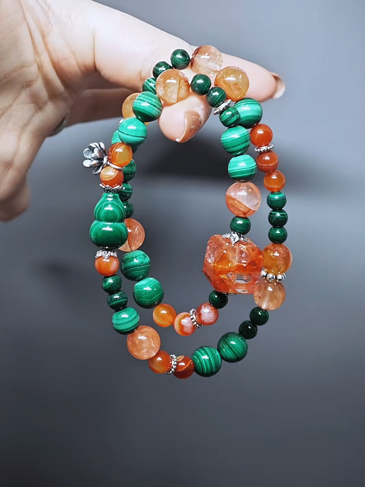 Dynamic display of the bracelet, resonating Red Fire Quartz breakthrough and Malachite vitality