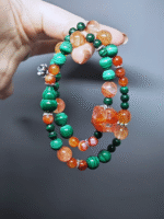 Dynamic display of the bracelet, resonating Red Fire Quartz breakthrough and Malachite vitality