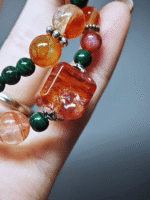 Wearing a double-strand bracelet with a Red Fire Quartz cushion, 8pcs 9mm Red Fire Quartz, 7mm Red Fire Quartz, 6mm Red Agate, 12pcs 8.5mm Malachite, 16pcs 6mm Malachite, 1pc Malachite gourd, showcasing fire-wood energy fusion