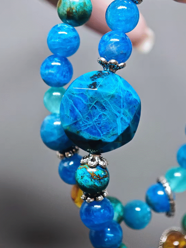 Close-up of the large 8mm Blue Apatite bead, core carrier of water-element energy