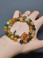 Dynamic display of the bracelet, resonating Tsavorite Garnet vitality and Yellow Fire Quartz breakthrough