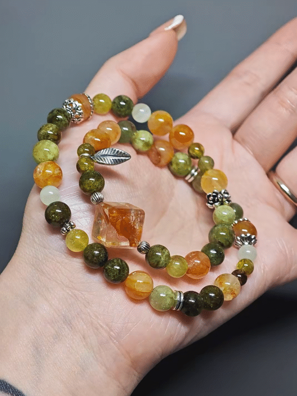 Multi-strand bracelet worn, building a daily energy field with Tsavorite Garnet, Yellow Fire Quartz, Xiu Jade, Hetian Jade