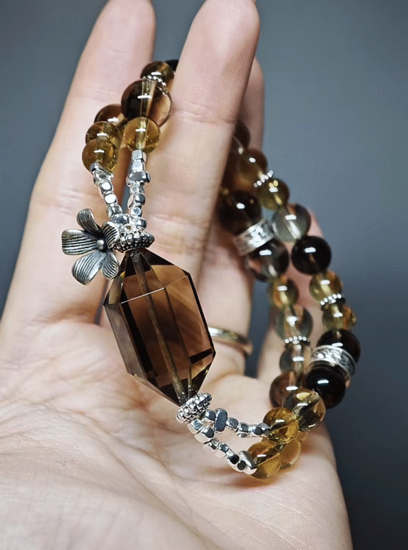 Close-up of silver flower clasp syncing with stones, metal-element connection hub