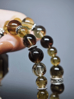 Double-strand bracelet displaying gradient layers of Smoky Quartz and Tea-Yellow Citrine, silver spacers amplifying earth-metal resonance