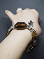 Wearing a double-strand bracelet with a Smoky Quartz double-terminated point, 9pcs 8mm Smoky Quartz, 10pcs 8mm Tea-Yellow Citrine, 13pcs 6.5mm Tea-Yellow Citrine, adorned with silver flower clasp, showcasing earth-metal energy fusion