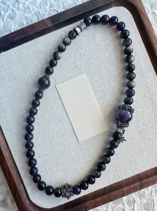 Details of the Amethyst and Silver Obsidian Capricorn bracelet, interpreting water-metal energy synergy for zodiac protection