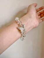 Details of Clear Quartz and silver butterfly bracelet, spiritual protection design with metal-element energy