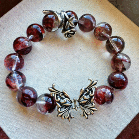 Design detail of Blood Red Fire Quartz bracelet, fire-metal protection of silver butterfly & rose