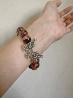 Wearing detail of Blood Red Fire Quartz bracelet, fire-metal synergy of silver & quartz