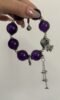 Close-up of Uruguay Amethyst bracelet with silver butterfly and bell accents, showcasing water-metal energy resonance