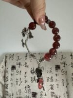 Close-up of Strawberry Quartz bracelet, silver totem’s red-fire & metal energy secrets