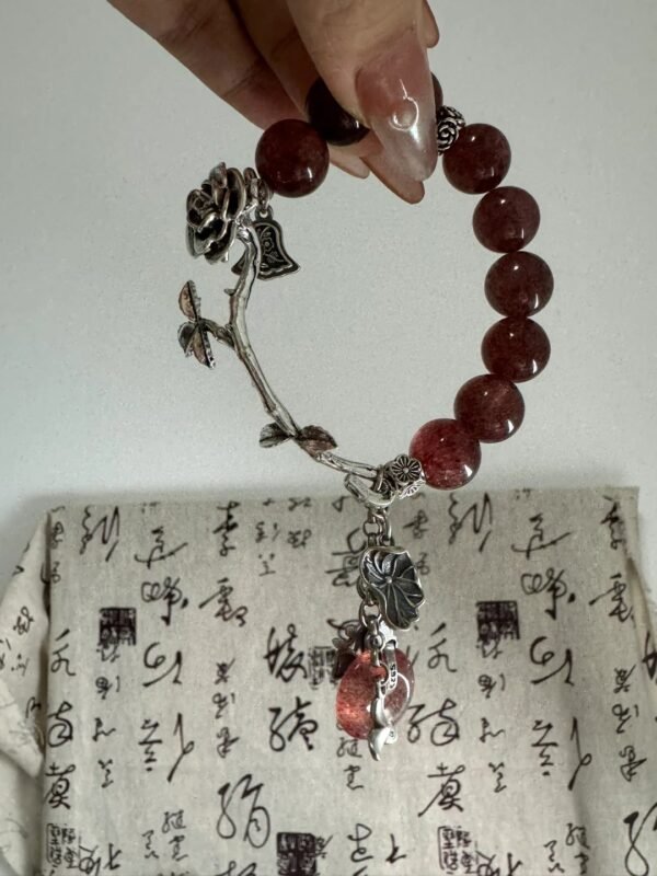 Detail of Strawberry Quartz bracelet, silver accents and beads’ red-fire & metal synergy