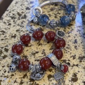 Close - up of 16mm/18mm Red Agate and Blue Crystal bracelets, with silver accents showing fire - metal energy resonance