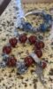 Close - up of 16mm/18mm Red Agate and Blue Crystal bracelets, with silver accents showing fire - metal energy resonance