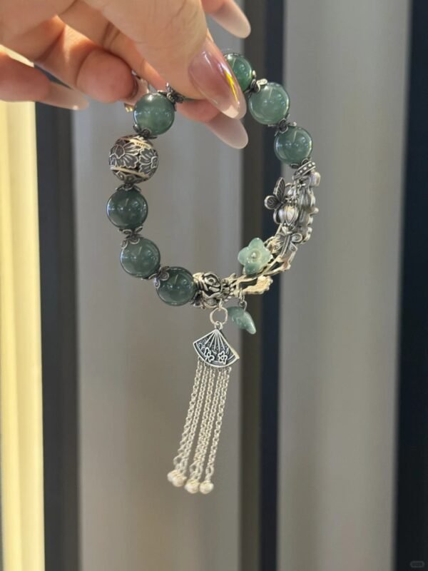 Tassels swaying on jadeite bracelet, earth-metal energy flowing dynamically
