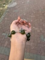 Palm view of Green Grape Xiu Jade bracelet, intimate wood-metal energy resonance