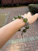 Wrist view of Green Grape Xiu Jade bracelet, daily wood-element nourishment