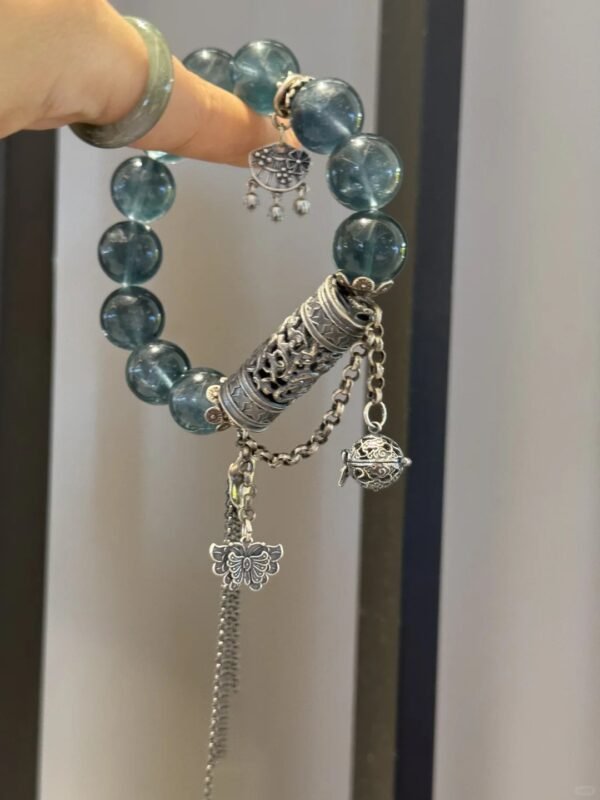 Hand detail of Blue Fluorite bracelet, silver totems’ water-metal secrets