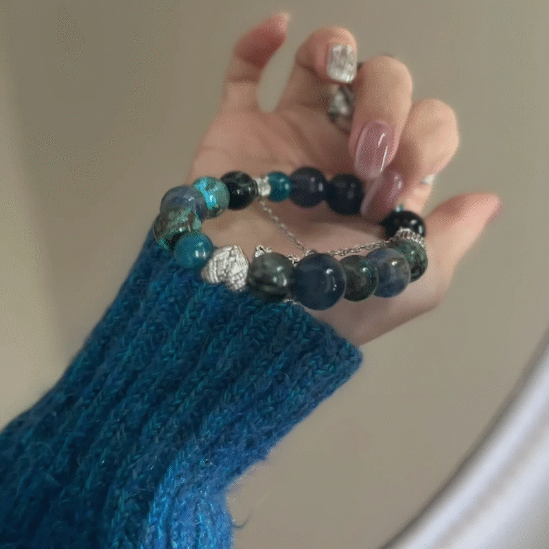 Mirror view of multi-gem bracelet, symmetric blue-metal balance