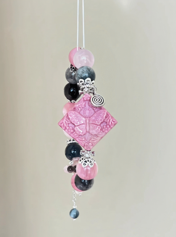 Close-Up of Rhodonite Butterfly Pendant, Fire Veins Etch Love & Transformation Totem